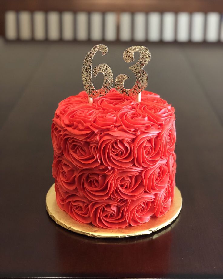 a red cake sitting on top of a wooden table