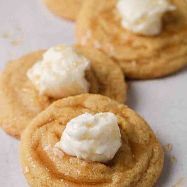 three cookies with whipped cream on top