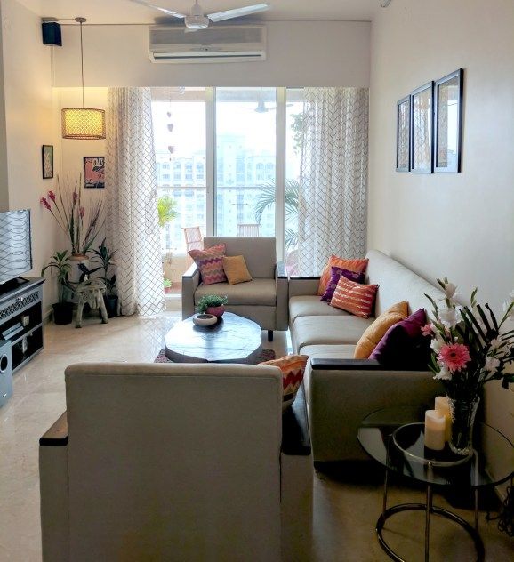 a living room filled with furniture and a flat screen tv