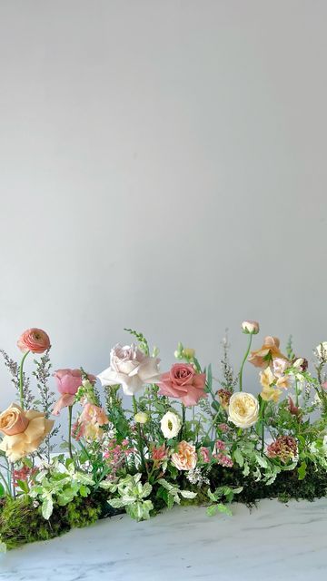 an arrangement of flowers arranged on a table