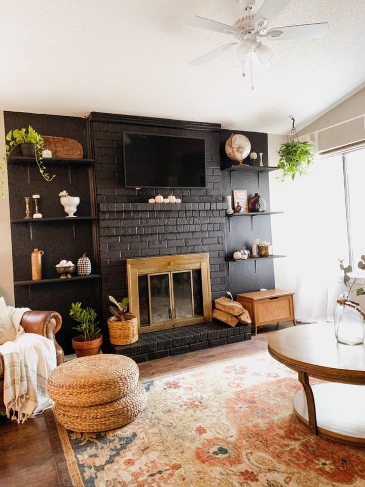 a living room filled with furniture and a fire place next to a wall mounted tv