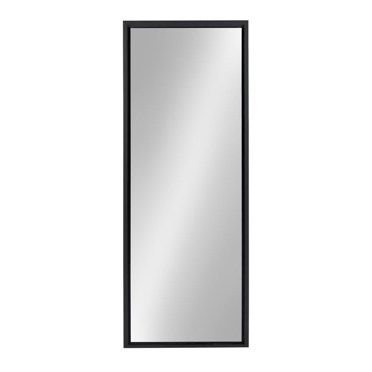 a black framed mirror on a white wall