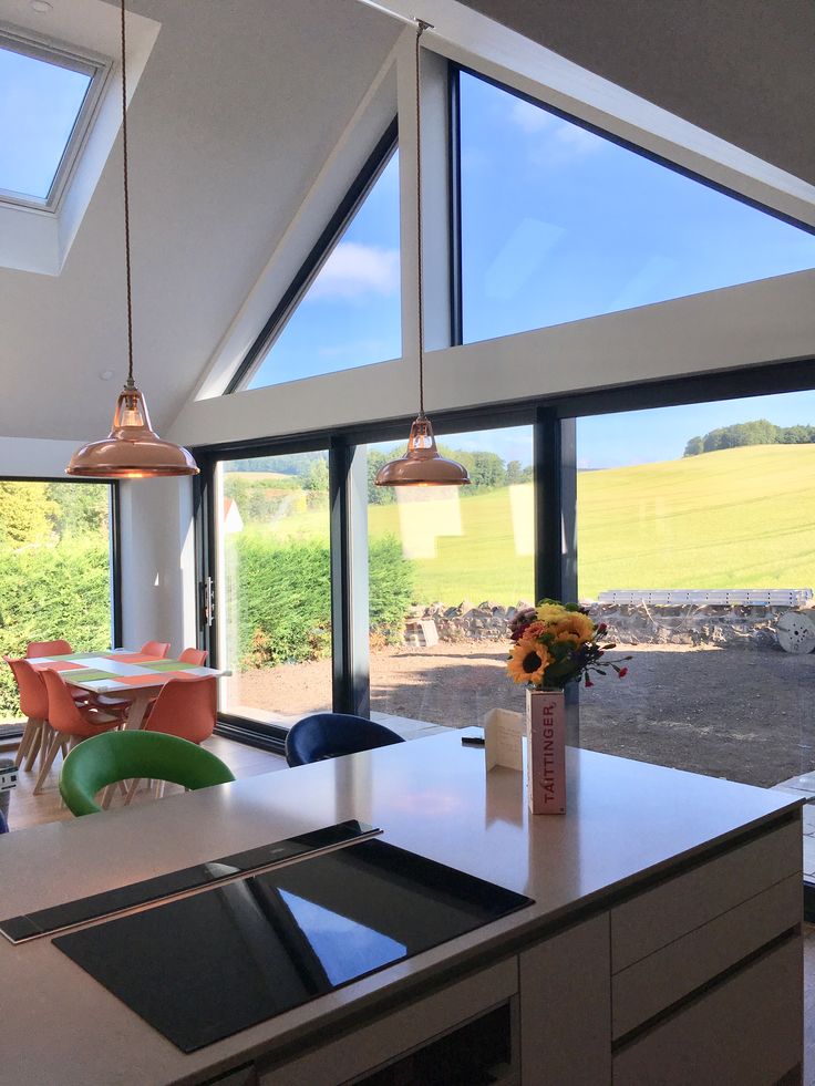 an open kitchen and dining room with large windows