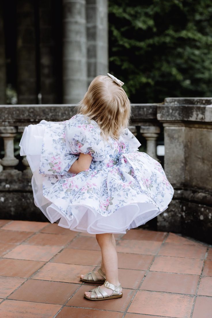 This cupcake-style dress with soft floral organza, irresistible puff sleeves, and layers of the voluminous skirt is the perfect party style for any summer soirée. Sizes are available for ages from 1Y to 8Y. Handmade in Europe. Spring Princess Bubble Dress For Dress-up, Tiered Tulle Skirt Dresses For Dress-up, Spring Princess Dress With Ruffled Skirt, Puff Sleeve Dress With Ruffles For Party, Spring Tutu Dress With Ruffles For Garden Party, Spring Garden Party Tutu Dress With Ruffles, Summer Princess Dress With Ruffles And Tiered Shape, Organza Dresses For Garden Party, Spring Party Twirl Dress With Ruffles