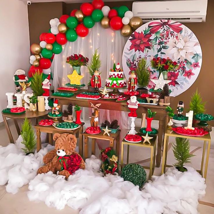 a christmas themed dessert table with balloons and decorations