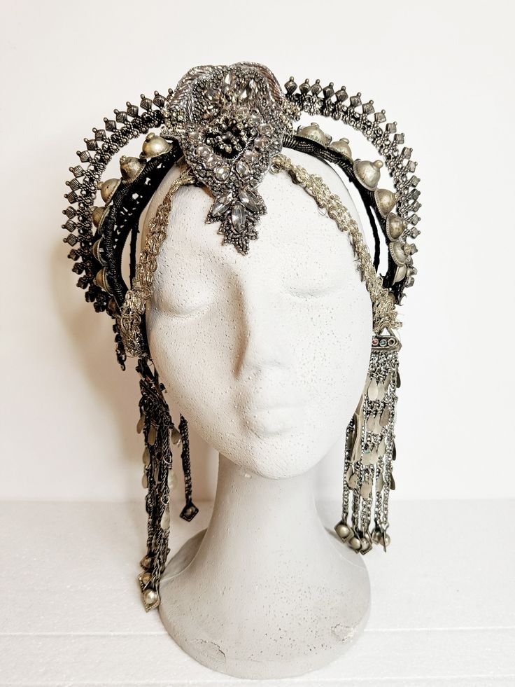 Indulge your inner goddess with this exquisite Afghan tribal headpiece, a bold statement piece that exudes power and elegance. Handcrafted with a mix of intricate beads, embroideries, vintage rhinestones, and luxurious vegan leather, this stunning headpiece is a true work of art. Whether you're heading to a festival, a stage show, or a special performance, this headpiece is designed to make you stand out from the crowd with its captivating glamour and tribal allure. Crafted for comfort and light Adjustable Rhinestone Headpiece For Festival, Adjustable Rhinestone Festival Headpiece, Adjustable Festival Headpiece With Rhinestones, Festival Jewelry With Rhinestones, Ceremonial Crown Headpiece For Festivals, Traditional Crown Headpiece For Parties, Bohemian Festival Headband Headpieces, Traditional Headband For Party, Bohemian Crown Headpiece For Festival