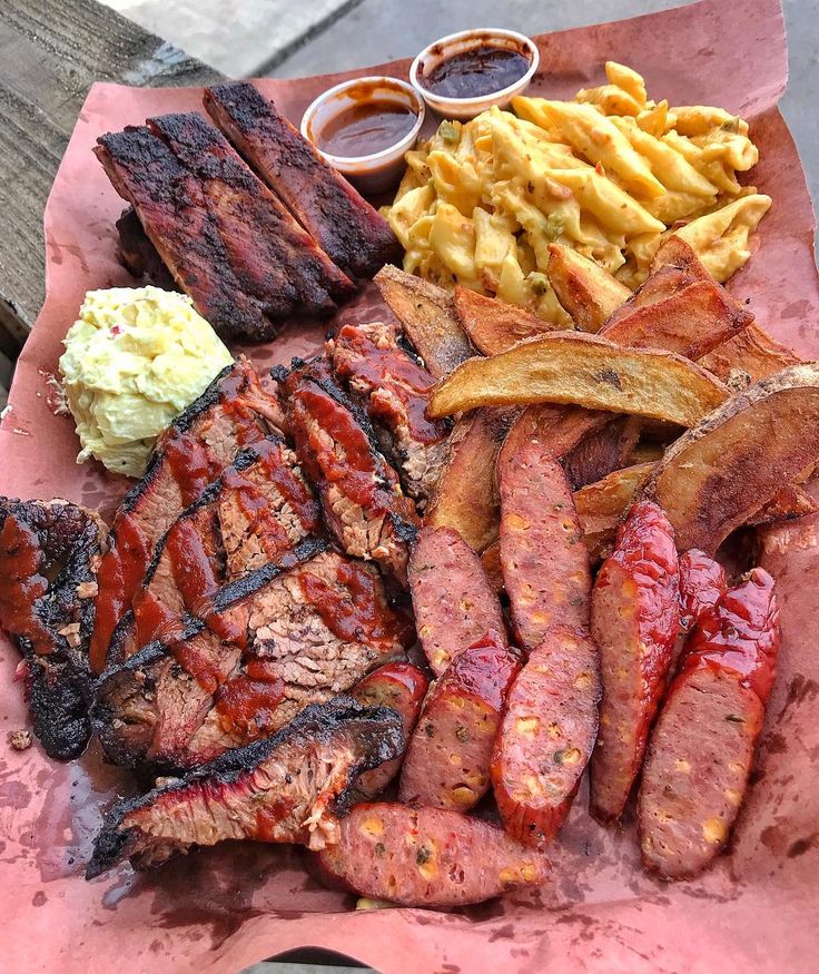 there are many different types of food on this plate, including meat and potatoes with sauces