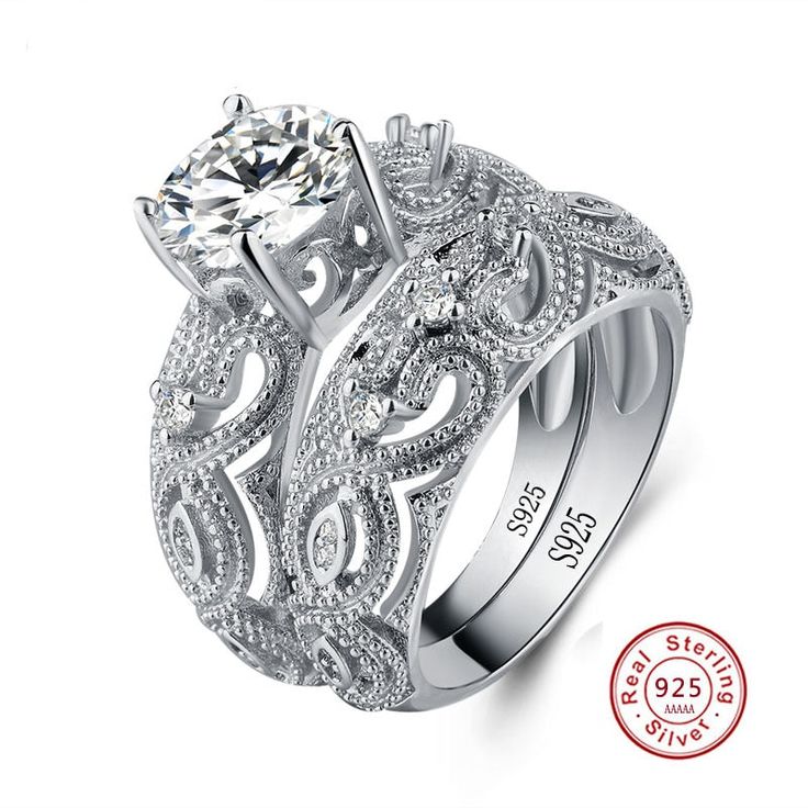 a white gold engagement ring set with an intricate design