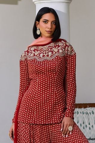 Red kurta with bandhani pattern and marodi, sequin embroidered neckline. Paired with sharara and dupatta. - Aza Fashions Red Dori Work Kurta For Reception, Fitted Red Salwar Kameez With Dabka Work, Fitted Red Anarkali Set With Dabka Work, Fitted Red Salwar Kameez With Zari Work, Fitted Red Anarkali Set With Dori Work, Wedding Red Palazzo Set With Dabka Work, Red Sharara With Dabka Work For Reception, Fitted Red Sharara With Traditional Drape, Fitted Red Sharara For Eid