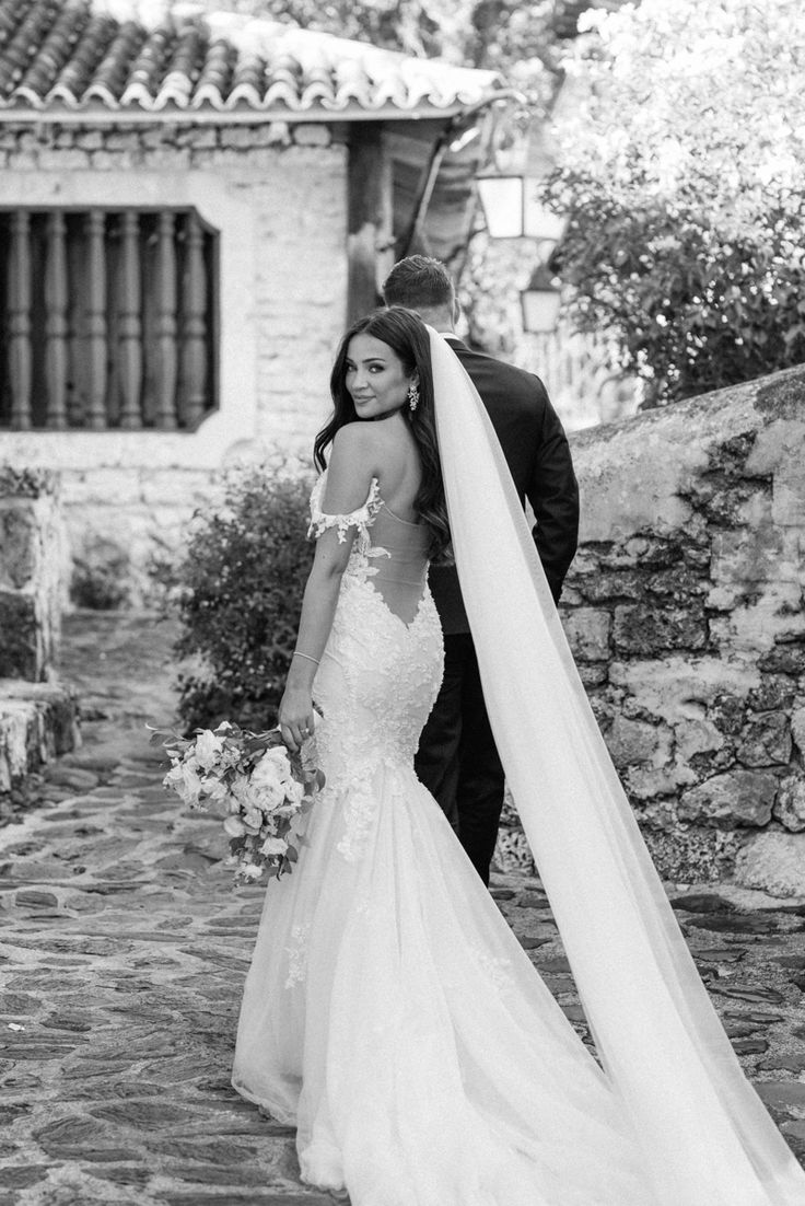 a bride and groom walking down the street