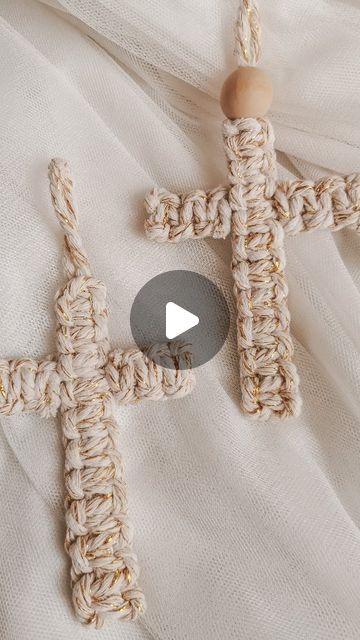 a crocheted cross with a wooden bead on it