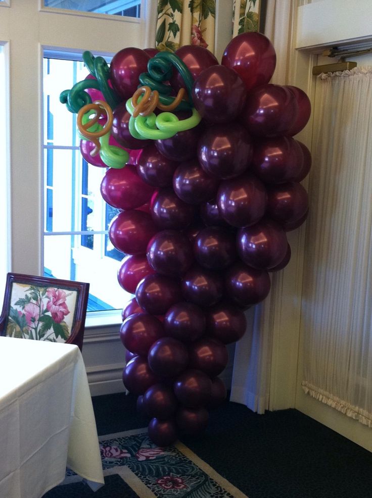 a bunch of balloons that are in the shape of a grape with snakes on them