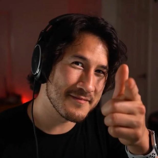 a man with headphones on giving the thumbs up