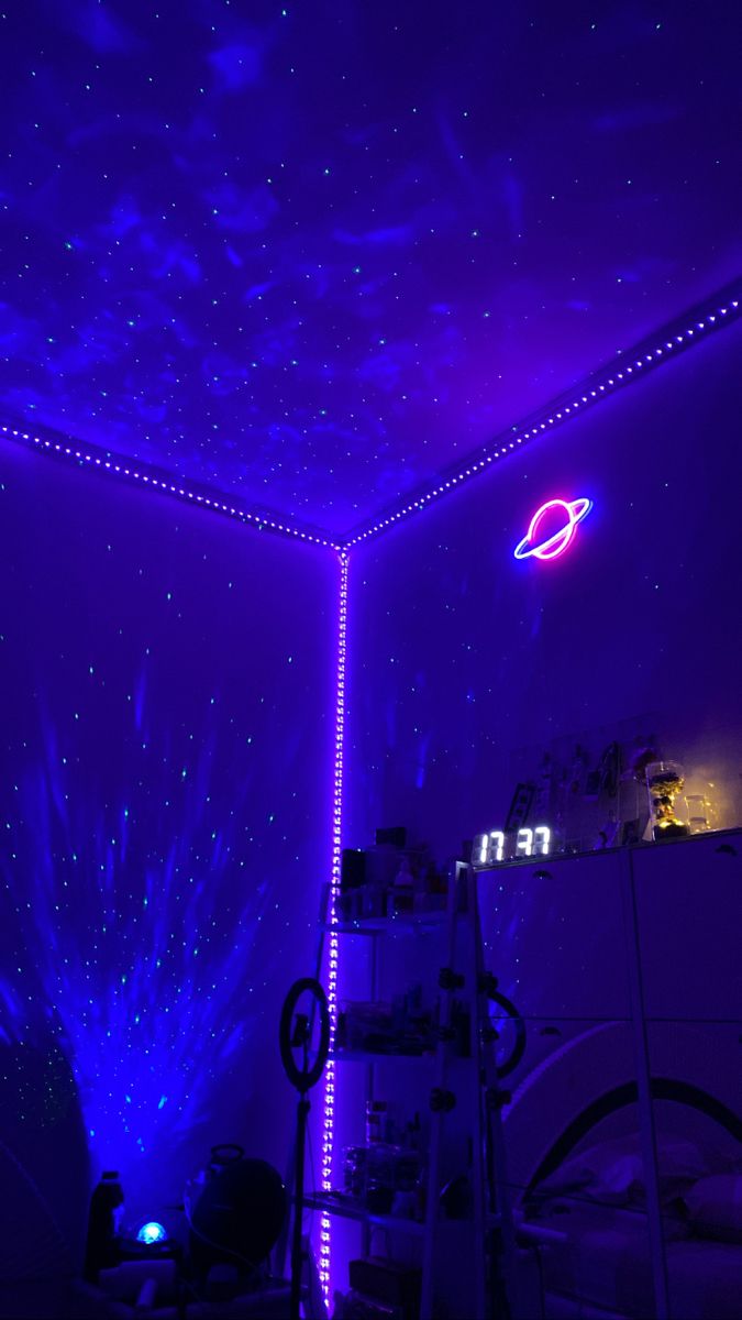 a room that has some lights on the ceiling and stars in the sky above it