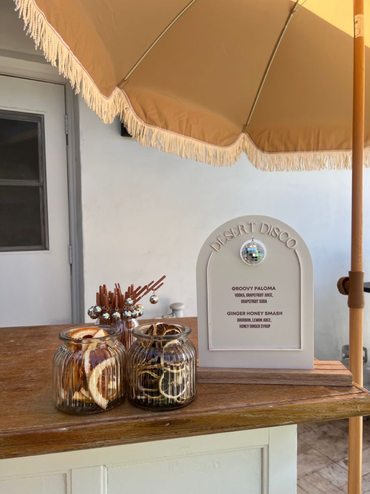 an umbrella and some jars on a table