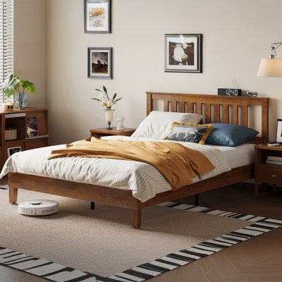 a bed room with a neatly made bed and two night stands on the side tables