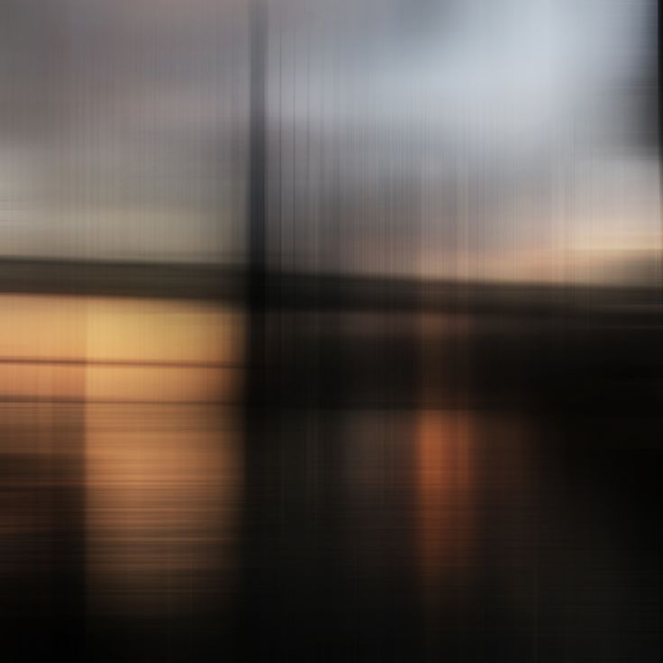 blurry photograph of water and sky at sunset