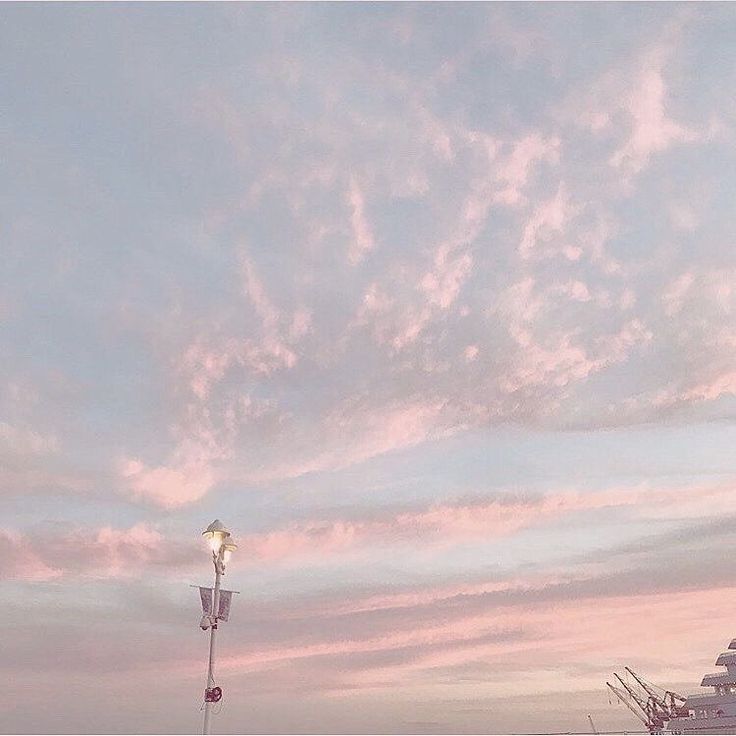 the sky is pink and blue with clouds