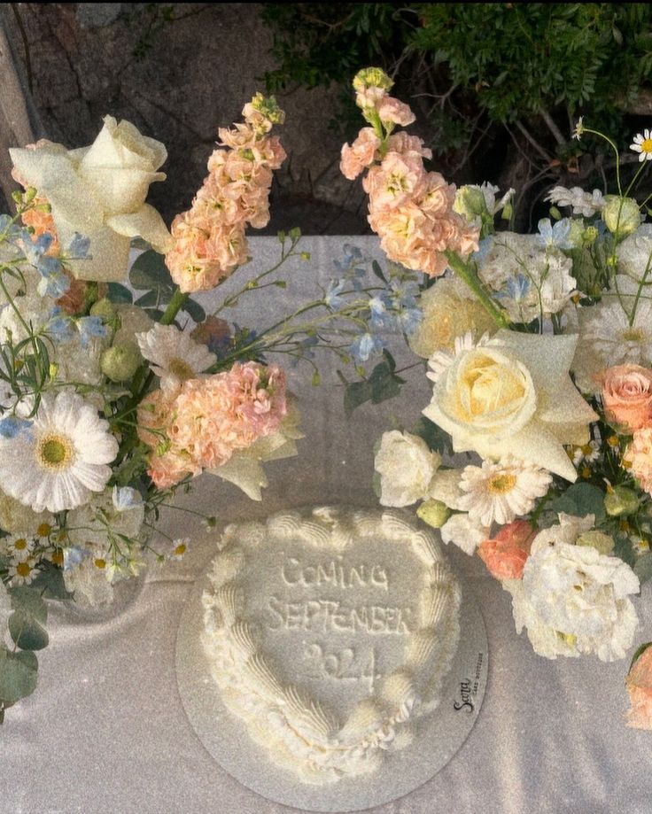 there is a cake and flowers on the table