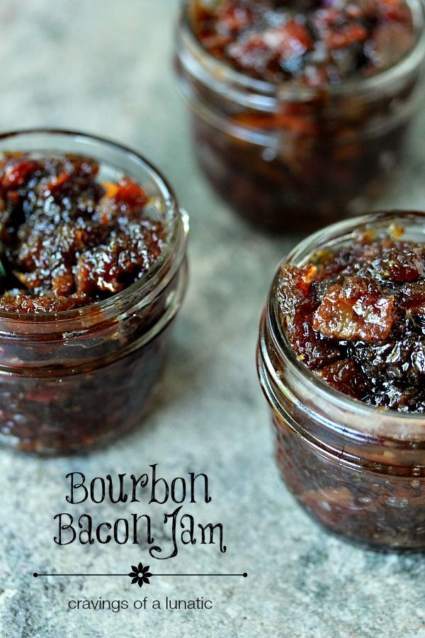 two jars filled with jam sitting on top of a table