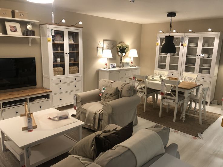 a living room filled with furniture and a flat screen tv sitting on top of a wooden table