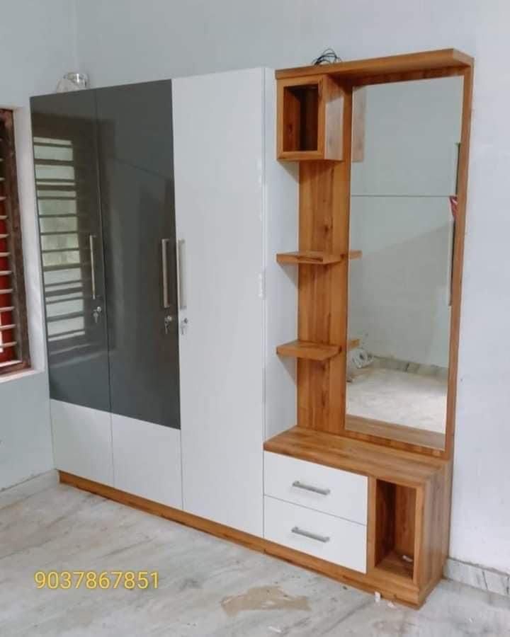 an empty room with a large mirror and wooden shelves in the corner, next to a white wall