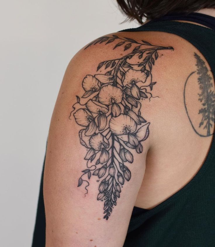 a woman's arm with flowers on it