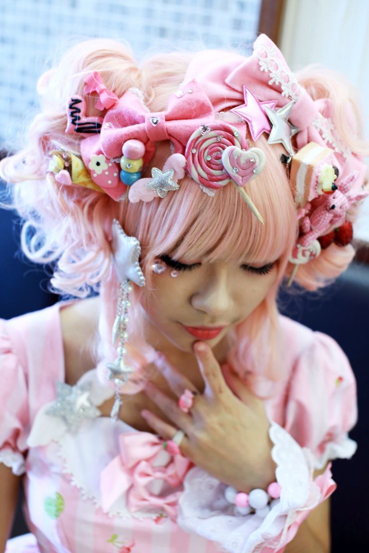 a woman with pink hair is dressed up like a princess and holding her hand to her face