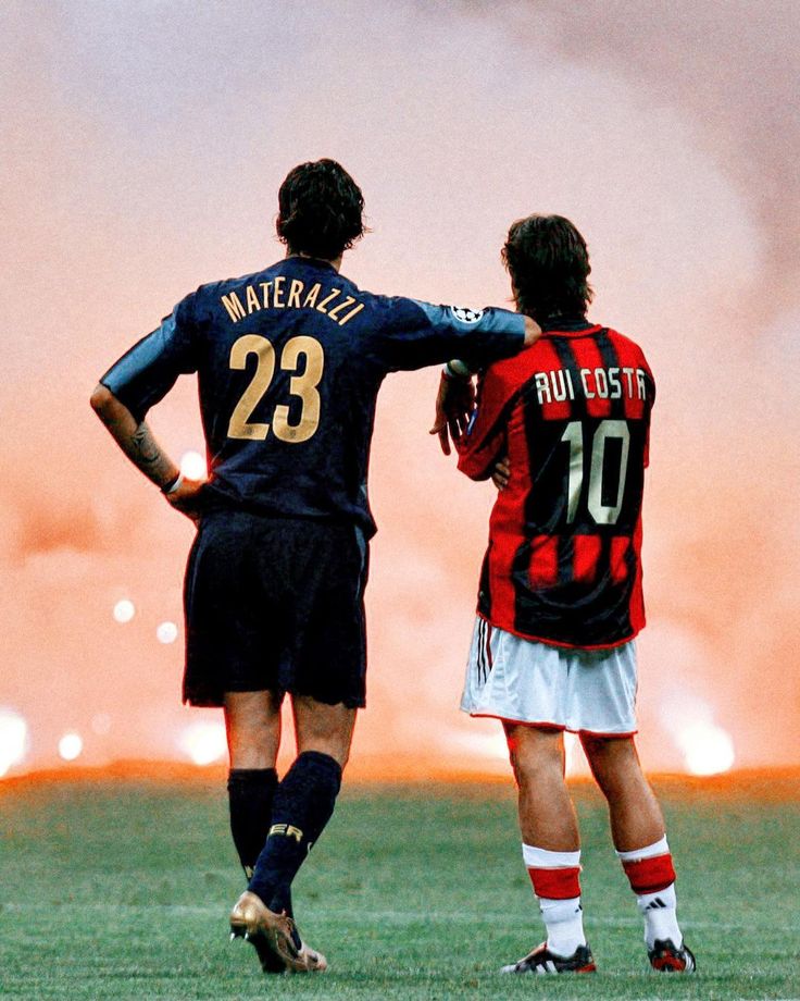 two soccer players are facing each other on the field as fireworks go off in the background