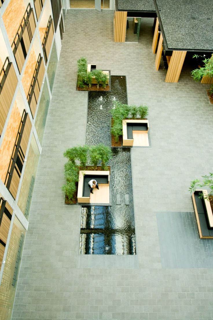 an aerial view of a courtyard with benches and plants