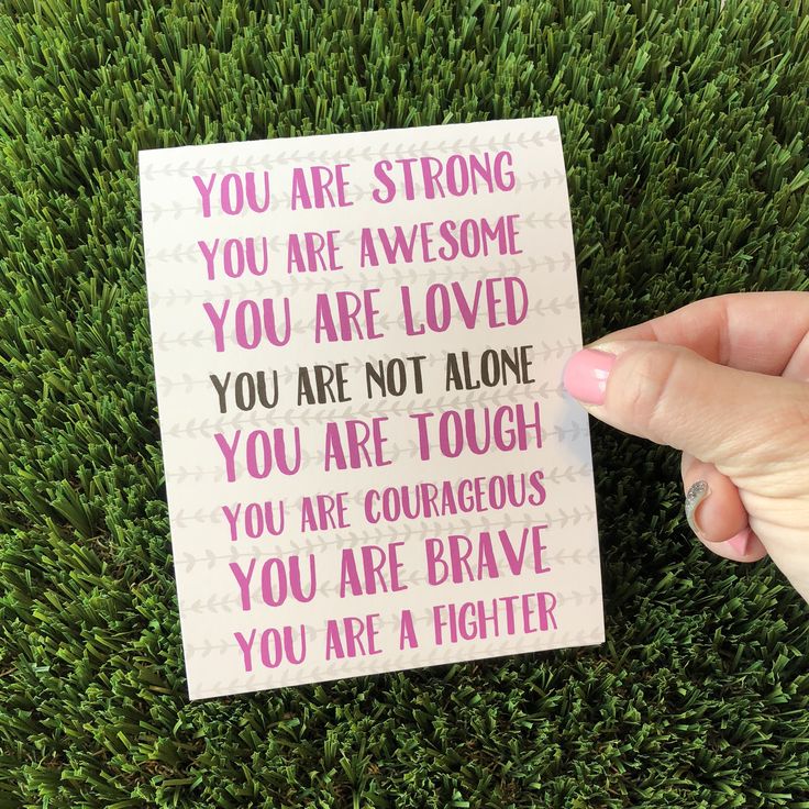 someone holding up a card that says you are strong