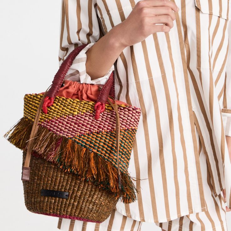 Designer Akosua Afriyie-Kumi Founded This Line Of Bags To Showcase The Spirit & Weaving Techniques Of The Women From Ghana. A Crowd Favourite, The Tia Is Back In A New Color-Way Showcasing Intricately Fashioned Raffia Patterns. It Has A Spacious Silhouette That's Perfectly Sized To Bring Order To Your Essentials. This Striking Top Handle Bag Is Functional & A Lovely Addition To Any Outfit. 27cm H X 30cm W. Raffia/Leather/Linen. Inner Pocket. Spot Clean. Import. Designer Pink Satchel Bucket Bag, Pink Top Handle Bucket Bag, Designer Pink Bucket Bag For Travel, Multicolor Double Handle Shoulder Bag With Dust Bag, Designer Woven Bucket Bag, Luxury Multicolor Rectangular Bucket Bag, Designer Woven Bucket Shoulder Bag, Luxury Multicolor Bucket Bag With Removable Pouch, Designer Multicolor Bag With Braided Handles