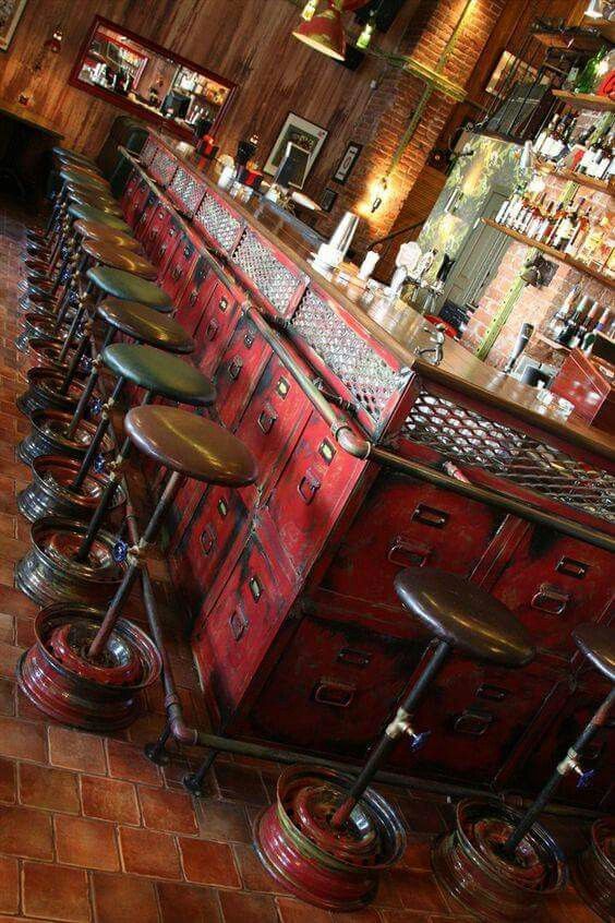 an old fashioned bar with stools in front of it