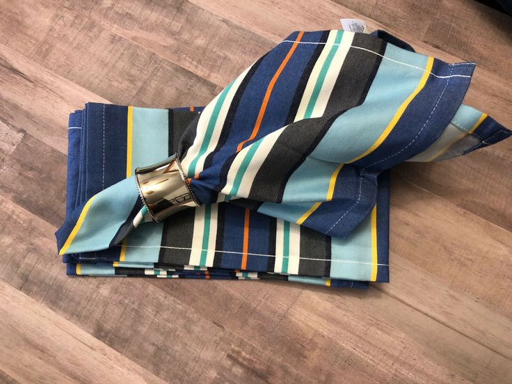 a blue striped bow tie laying on top of a wooden floor