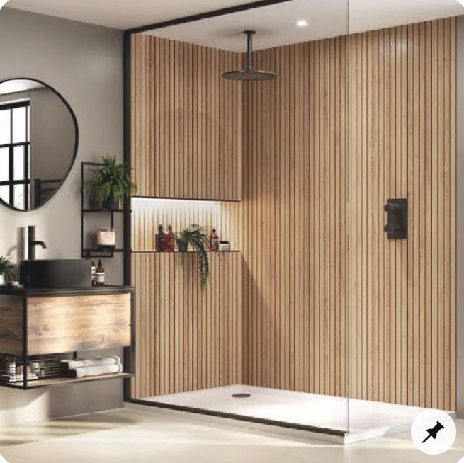 a bathroom with a wooden shower stall and mirror on the wall, along with a sink