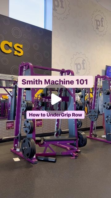 the smith machine 1011 is on display at an indoor facility in front of a sign that says smith machine 1011