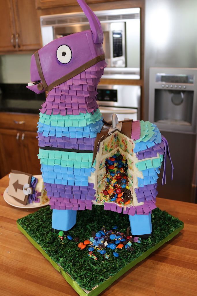 a purple horse made out of legos sitting on top of a wooden table in a kitchen