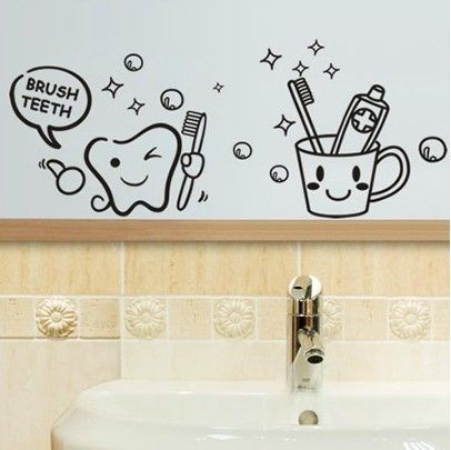 a bathroom wall with toothbrushes and toothpaste stickers on the walls