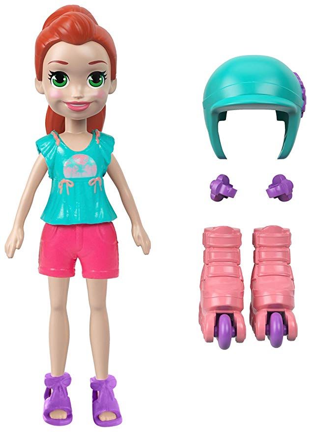 a doll with red hair and green eyes is next to roller skates on a white background