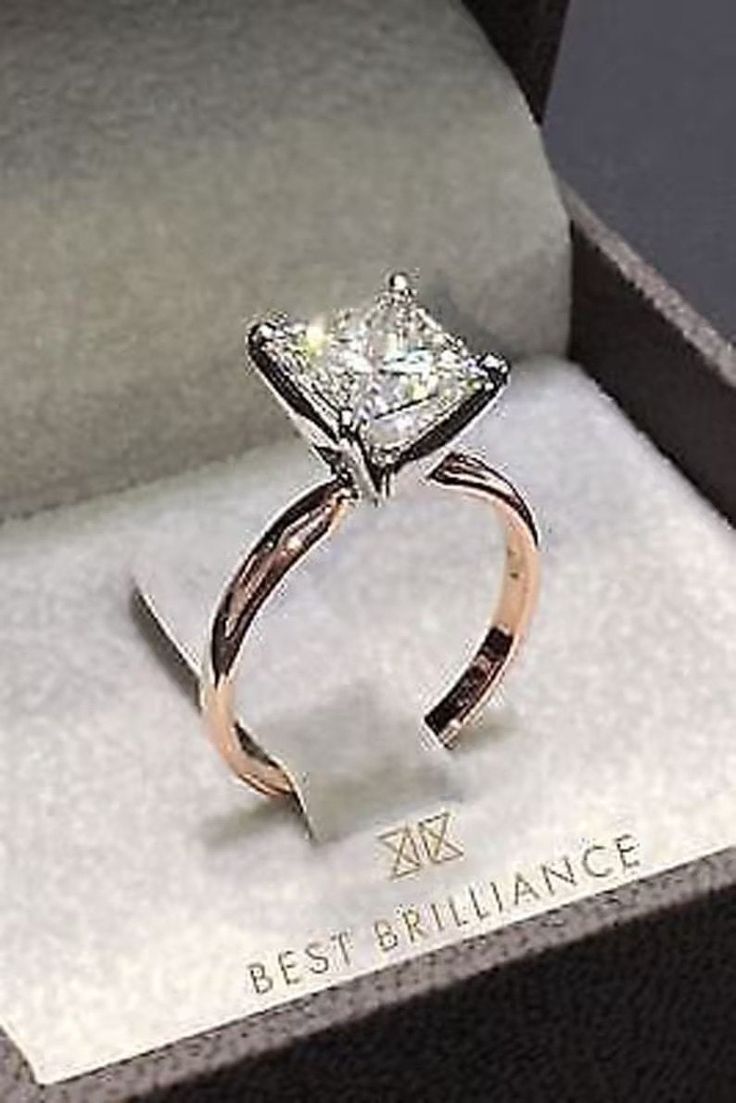 an engagement ring with a princess cut diamond set in 18k rose gold and white gold