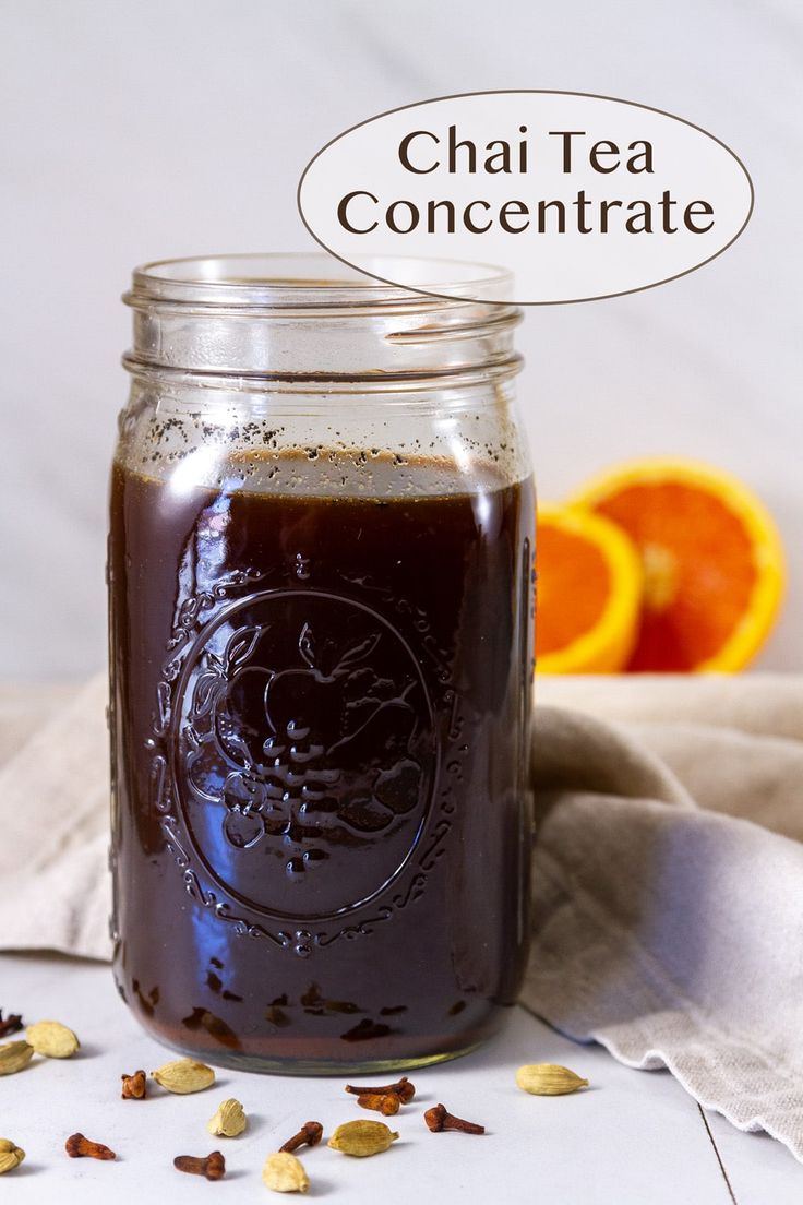 a jar filled with liquid next to an orange slice