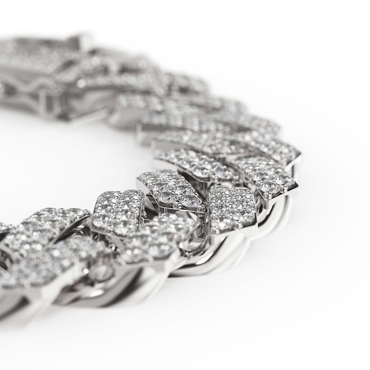 Elevate your style with the Golden Concept Cuban Link Bracelet, a masterpiece of luxury and craftsmanship. Crafted from premium sterling silver and adorned with natural Zircon gems, this bracelet radiates brilliance and sophistication. Weighing 42 grams and polished to perfection, it embodies elegance with a 12 mm thickness. Available in sizes S (17.5 cm), M (19 cm), and L (20.5 cm), it ensures a perfect fit, blending comfort with luxury. The meticulous attention to detail and flawless finishing White Gold Iced Out Cuban Link Jewelry, Iced Out White Gold Cuban Link Jewelry, White Gold Iced-out Cuban Link Jewelry, Dazzling Iced Out Cuban Link Jewelry, Luxury White Gold Chain Bracelet With Pave Setting, White Gold Cuban Link Jewelry With 17 Jewels, Dazzling Bracelets With Pave Setting In Cubic Zirconia, Sterling Silver Cuban Link Diamond Cut Jewelry, Sterling Silver Cuban Link Diamond-cut Jewelry