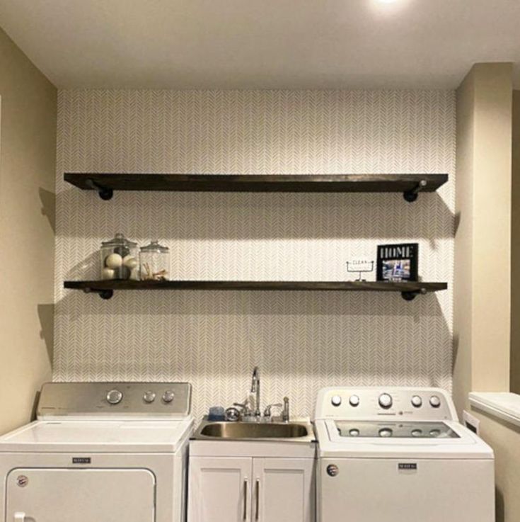 a kitchen with a washer and dryer in it