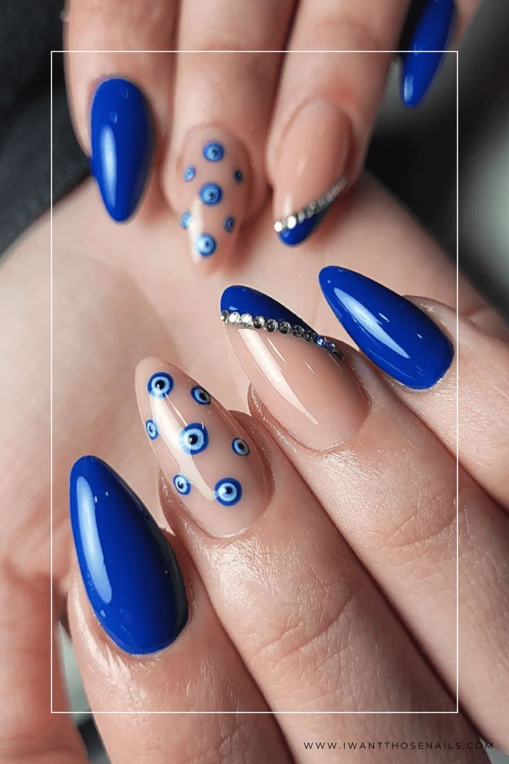 Achieve both style and protection by taking inspiration from these royal blue evil eye nails! This captivating nail art is not only highly fashionable but also believed to keep away negative energies. Get creative with different designs or simply go for an alluring single accent nail - stay glamorous while embracing positive vibes! Protection Eye Nails, Nail Art Evil Eye Design, Evil Eye Inspired Nails, Evil Nail Designs, Blue Eye Nail Art, Azul Nails Ideas, Blue Nails With Evil Eye, Evil Eye Nail Art Design, Royal Blue Nail Art Design