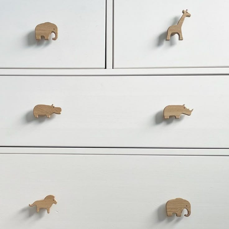 three drawers with wooden animals on them