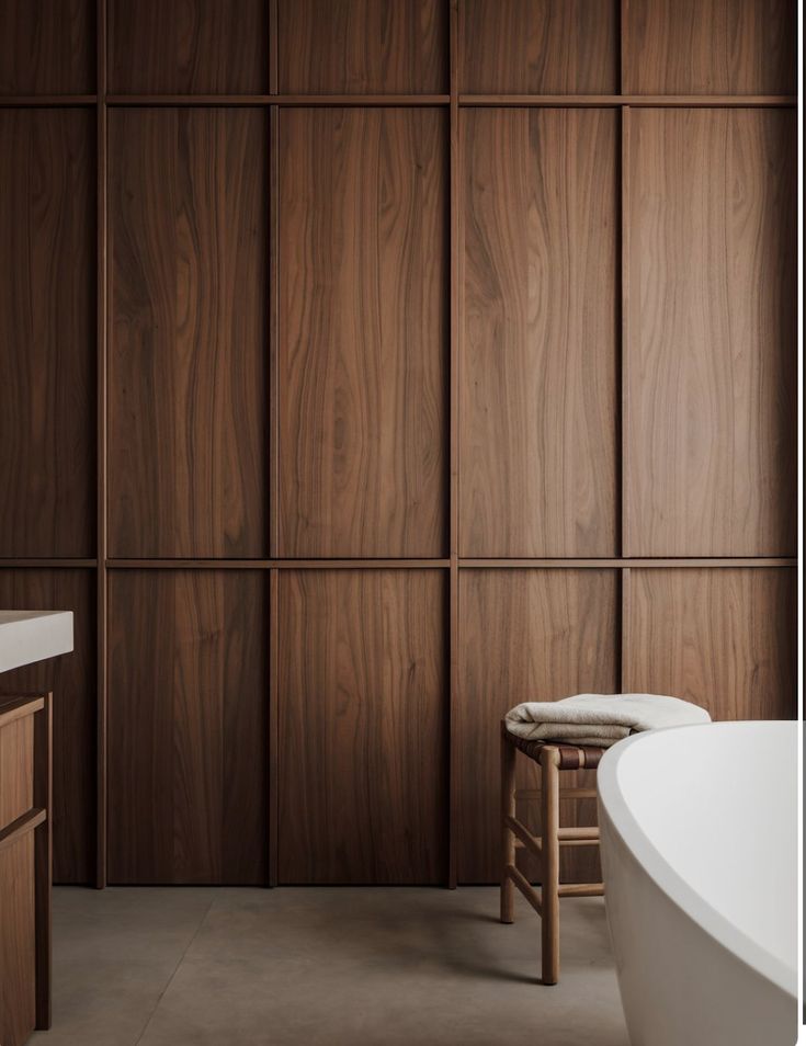 a bath tub sitting next to a wooden wall