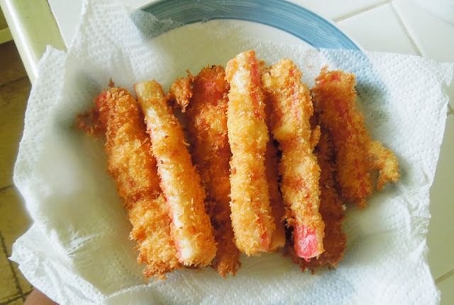 some fried food is sitting on a paper towel next to a blue and white plate