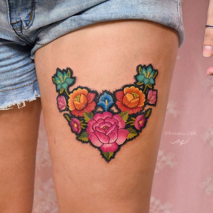 a woman's thigh with colorful flowers on it