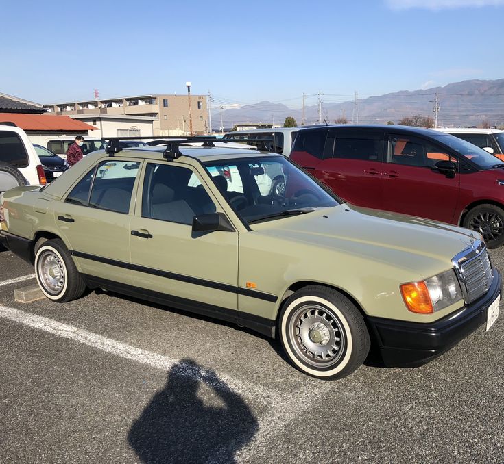 a car parked in a parking lot next to other cars