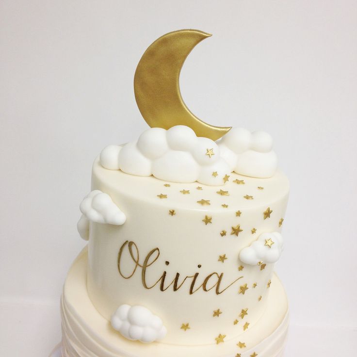 there is a white cake with gold stars and a crescent on top that says livia